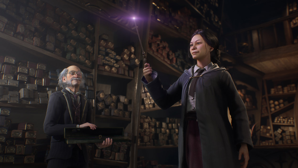 A man with grey hair watches a witch hold their wand as it starts to glow at the tip.