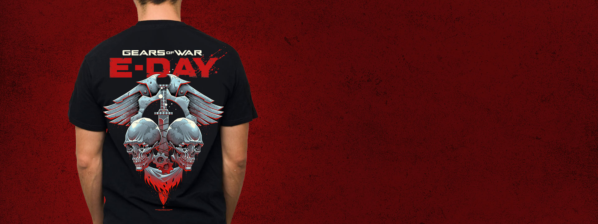 Back view of a man wearing a Gears of War E-Day T-shirt