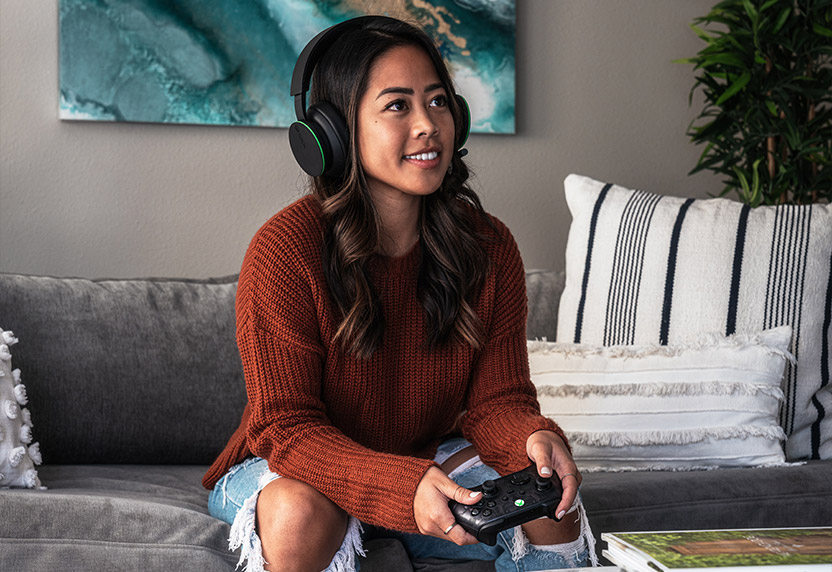 A person wearing a headset browsing available Quests on their Xbox console.