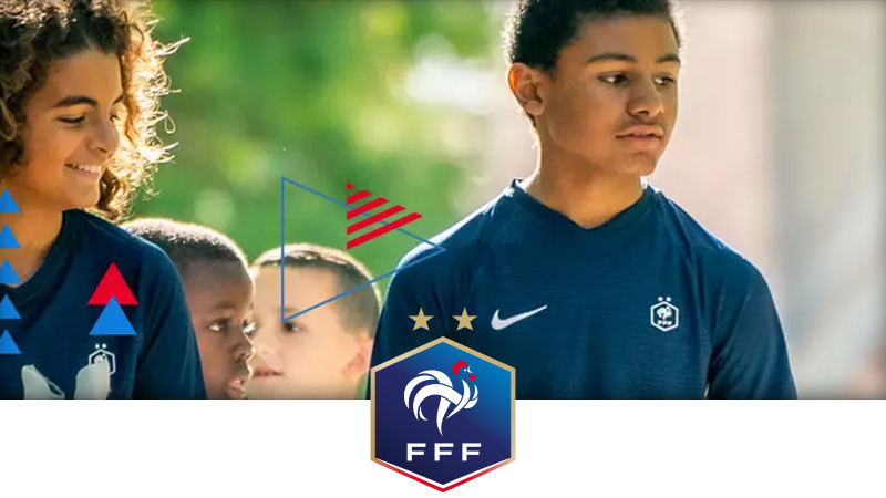 A group of young football players - both male and female - kitted out in French colours