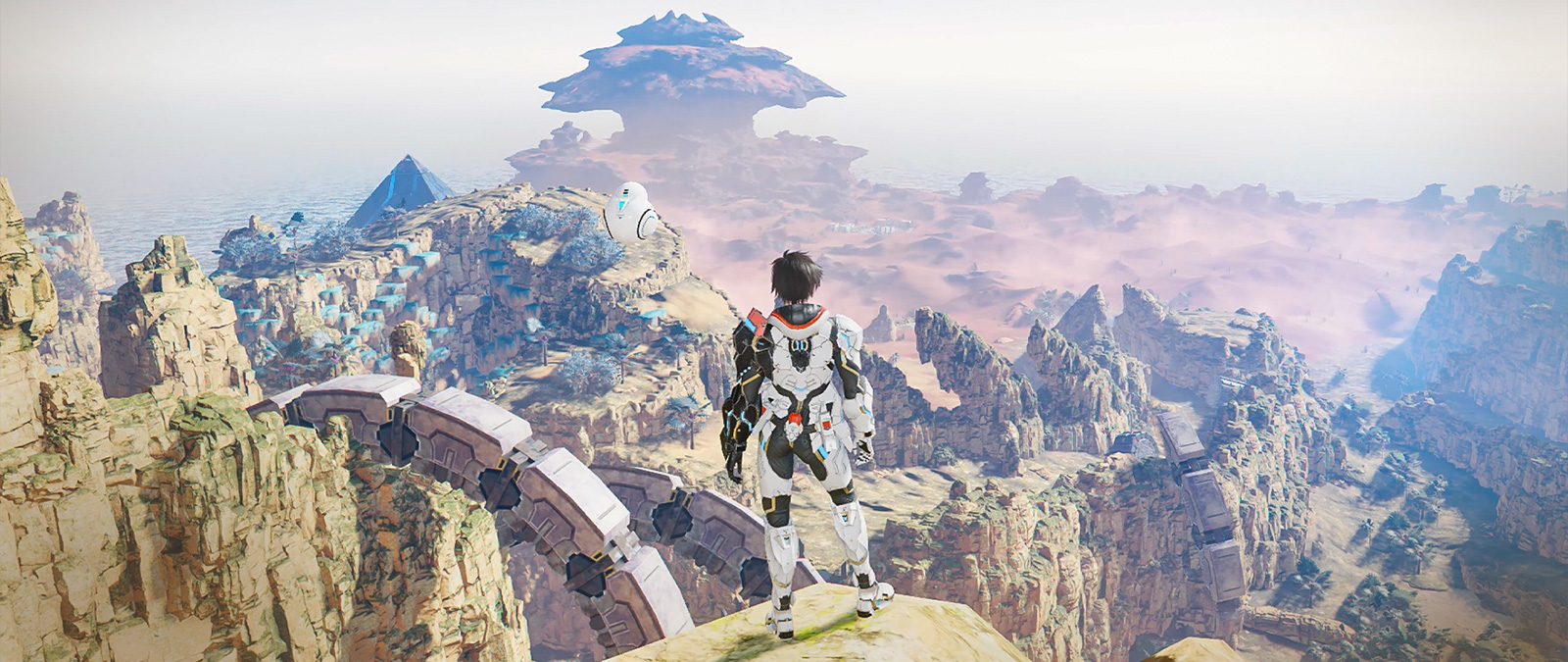 Een personage met een krachtpantser staat op een klif en kijkt uit over een vallei.
