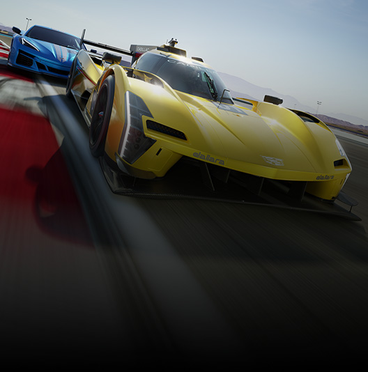 A blue Corvette and a Yellow Cadillac speed down a racetrack