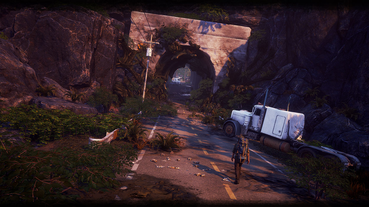 Character walking on a road towards a tunnel overgrown with greenery and an abandoned truck