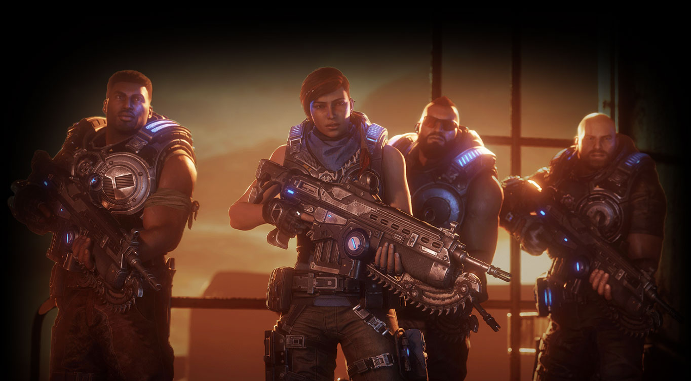 Gears 5. Kait Diaz és csapata egy ipari épület nagy ablaka előtt áll, amely a sivatagra néz.