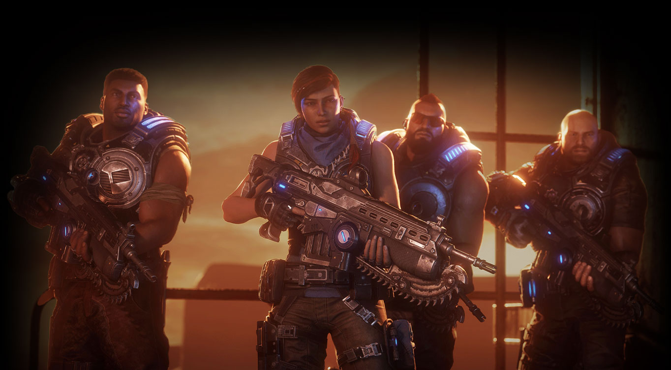 Gears 5. Kait Diaz a jej tím stoja pred veľkým priemyselným oknom, ktoré sa pozerá do púšte