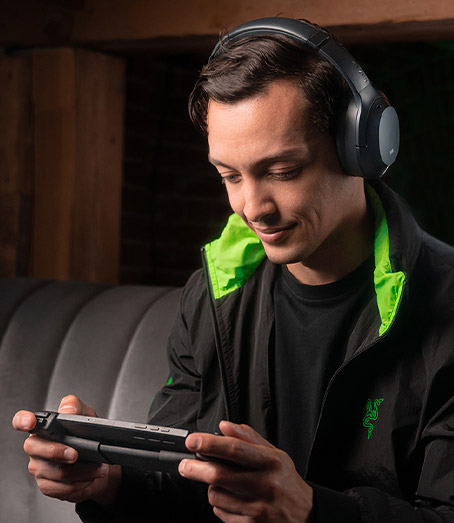 Looking down at a person playing the Logitech G Cloud Gaming Handheld showing the full front view.