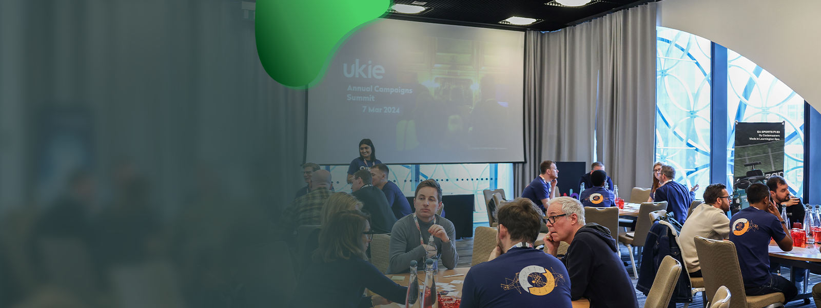 Photo of the Ukie Annual Campaigns Summit 2024, with event attendees in discussion around multiple conference tables