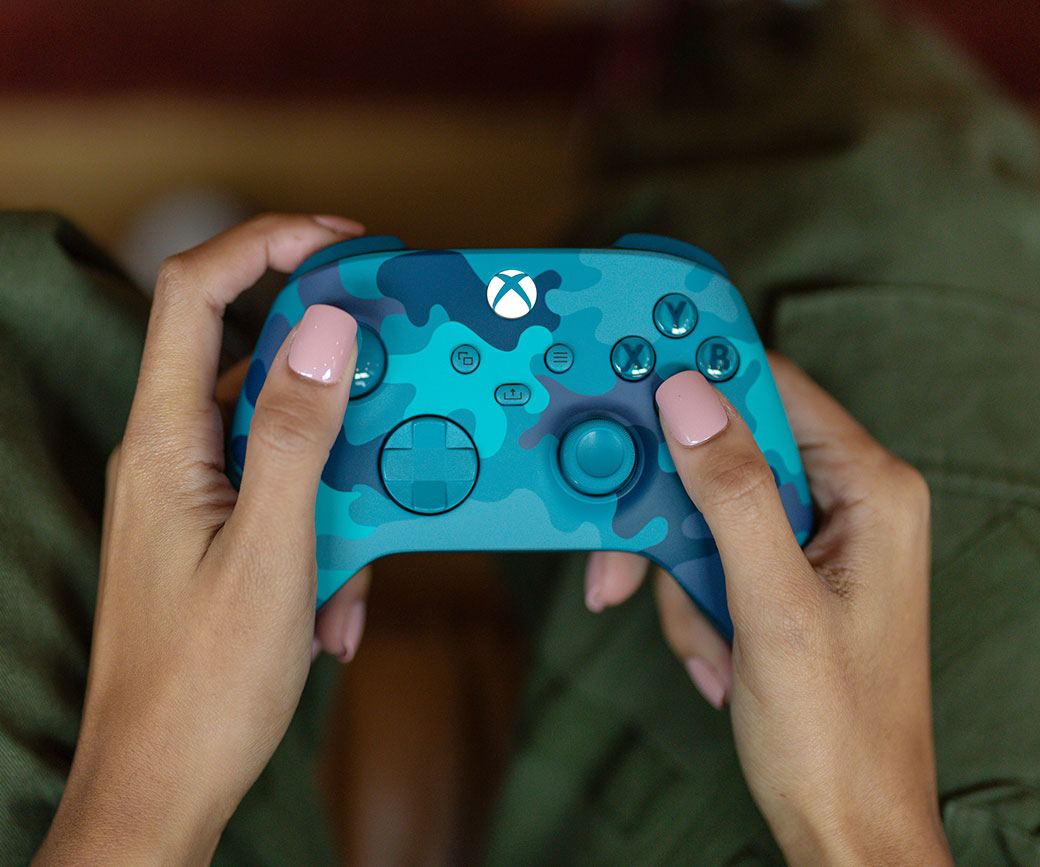 Top view of someone holding the Xbox Wireless Controller – Mineral Camo while seated