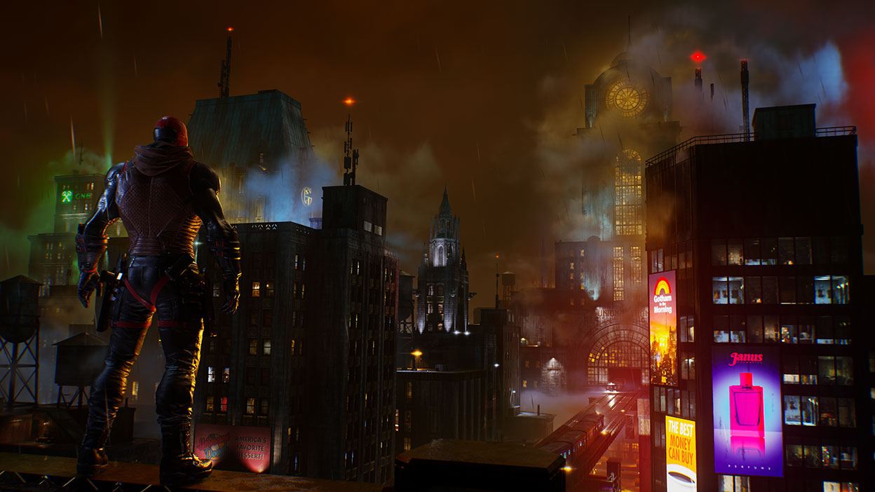 Red Hood stands on a roof top looking out over Gotham City.