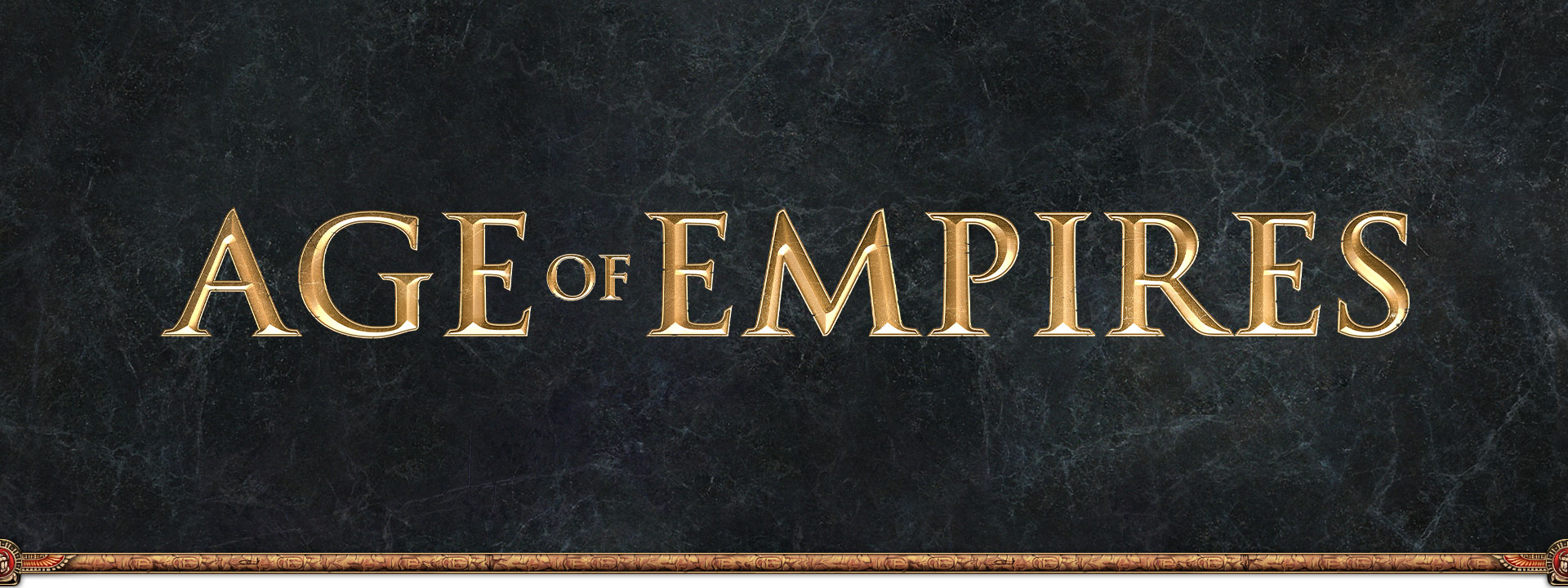 회색 점판암 배경 위에 그려진 Age of Empires 로고
