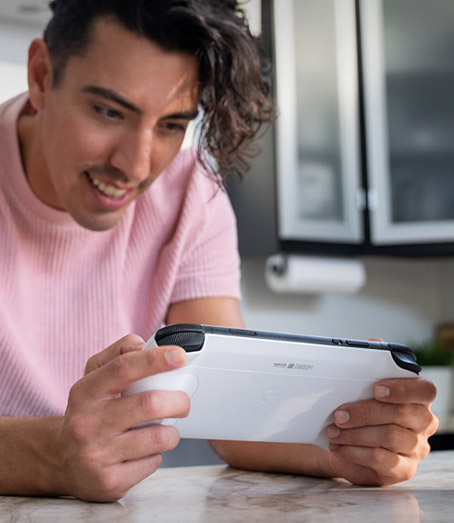 Front view of person playing the Logitech G Cloud Gaming Handheld showing the back of the device