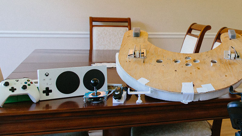 The components of Spencer’s custom adaptive controller set-up are displayed on a table.