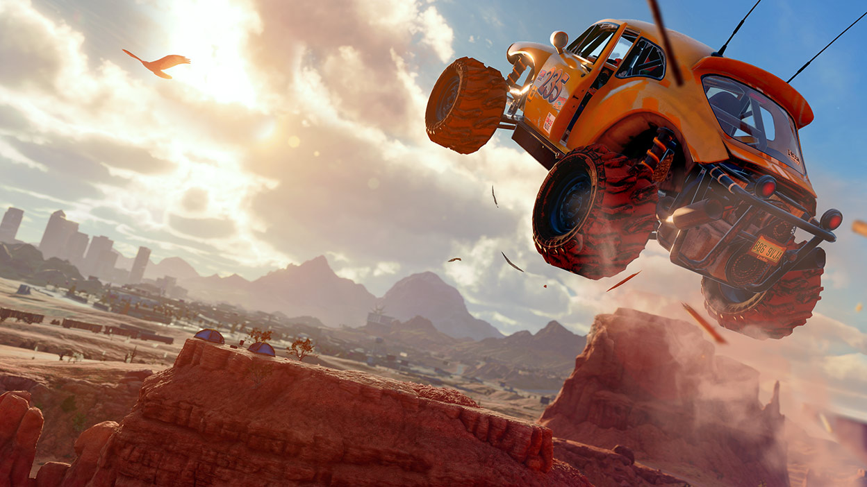 An off-road car soars above a canyon.