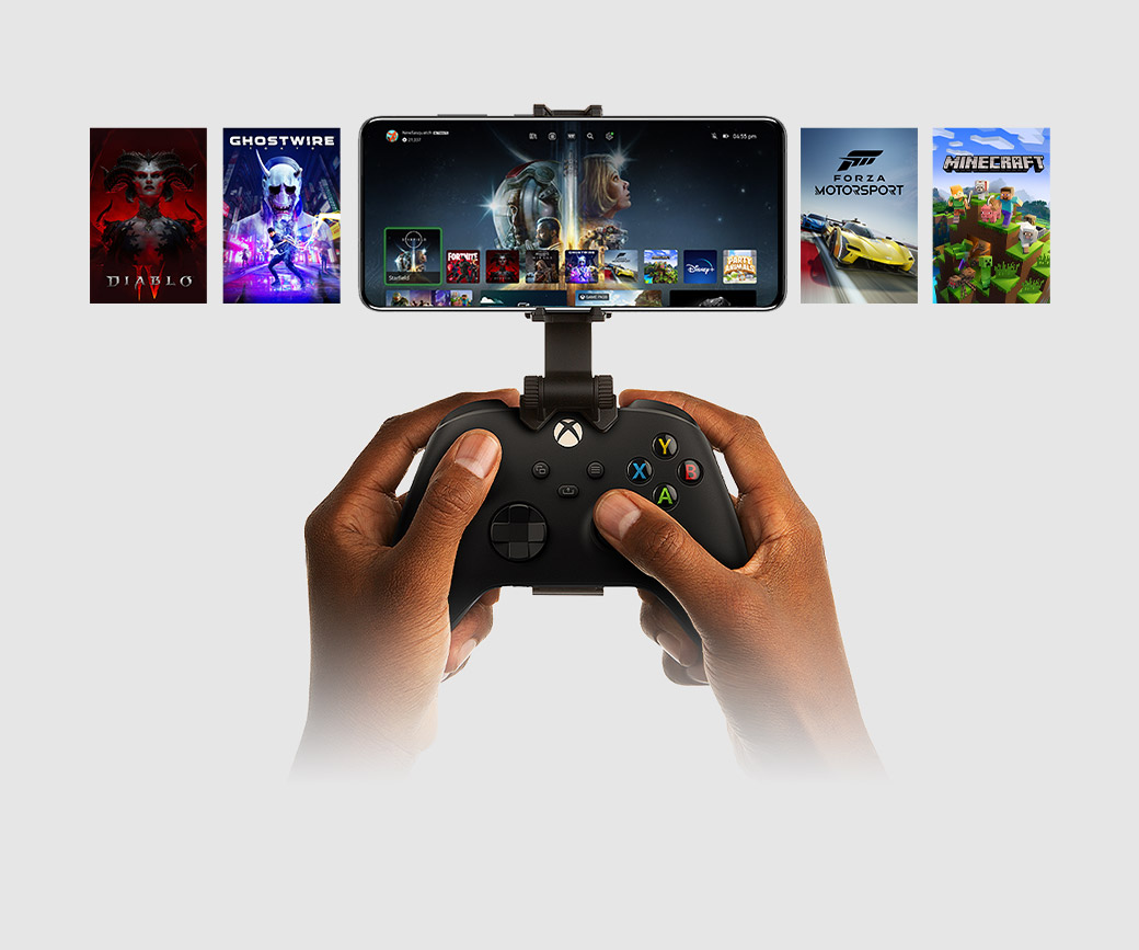 A mobile device is clipped onto an Xbox controller, showing a selection of titles to play.