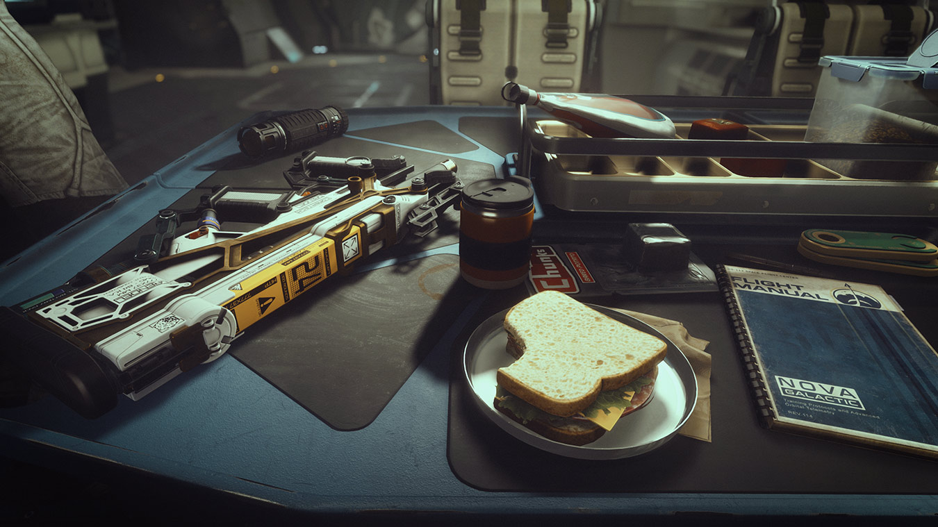 update main gallery with image: A table with a weapon, sandwich, flight manual and other miscellaneous items
