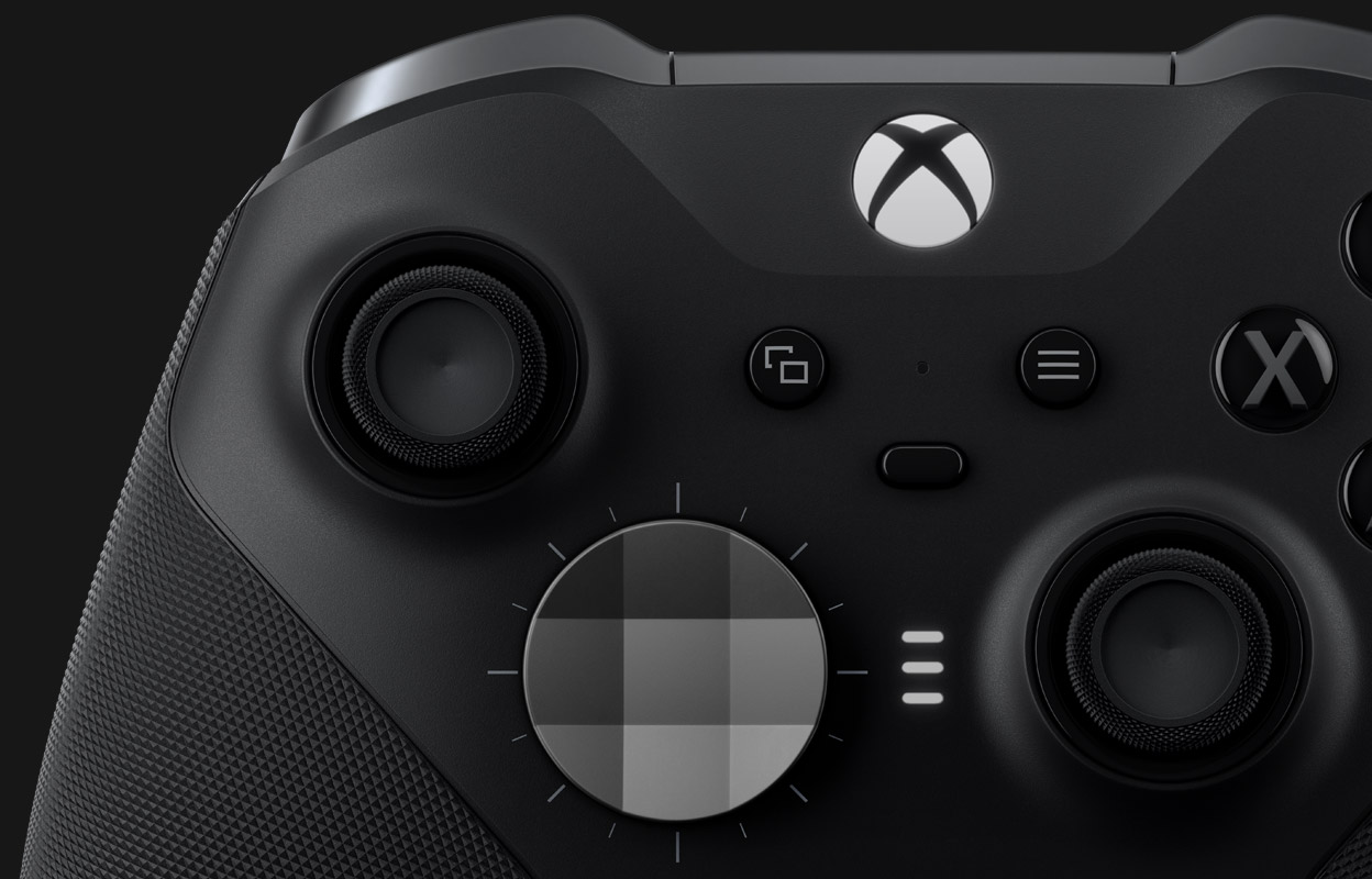 Close up of the front of the Xbox Elite Wireless Controller Series 2, with characters from Apex Legends peeking around the left side.