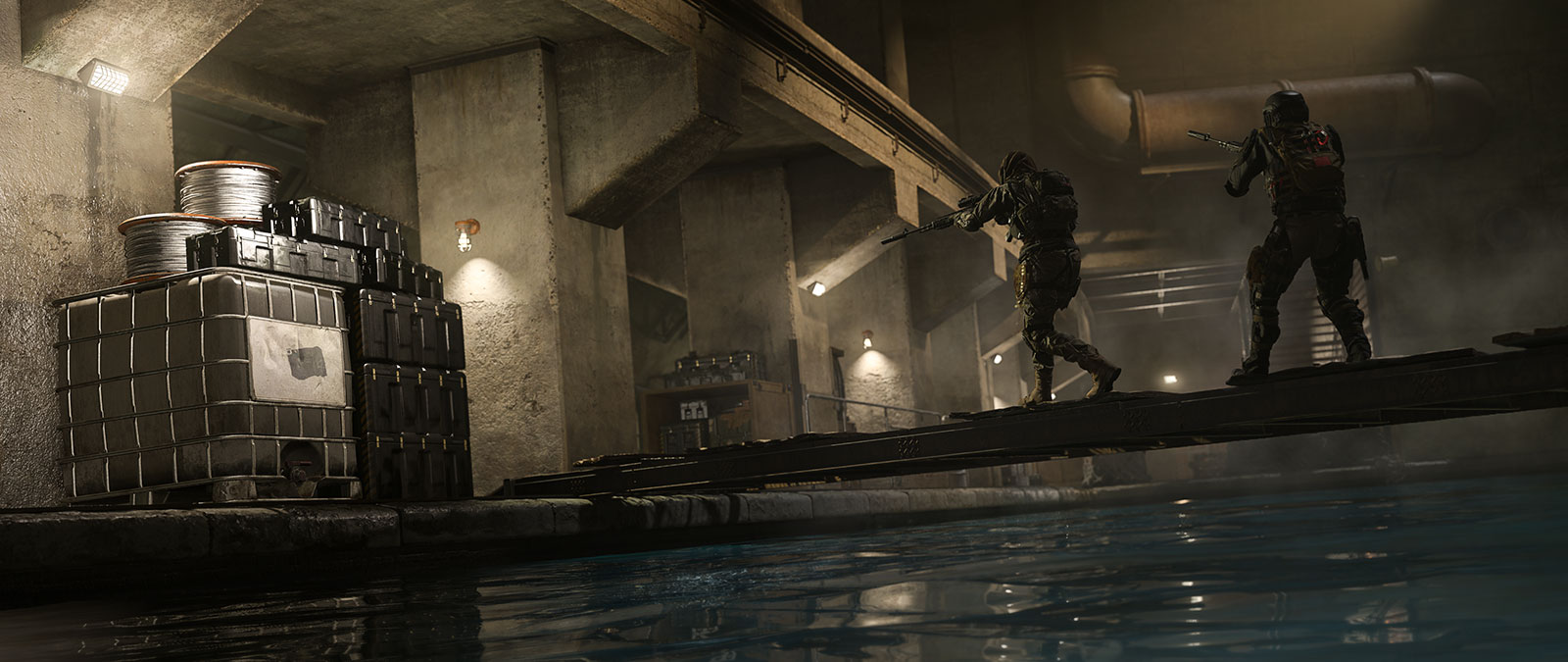 A pair of Operators proceed carefully in an industrial sewer.