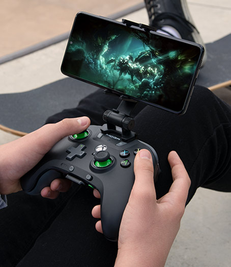MOGA XP5-X Plus Bluetooth Controller with a phone attached playing a game