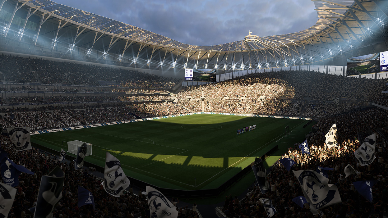 A large soccer arena as the sun begins to set on a cloudy day.
