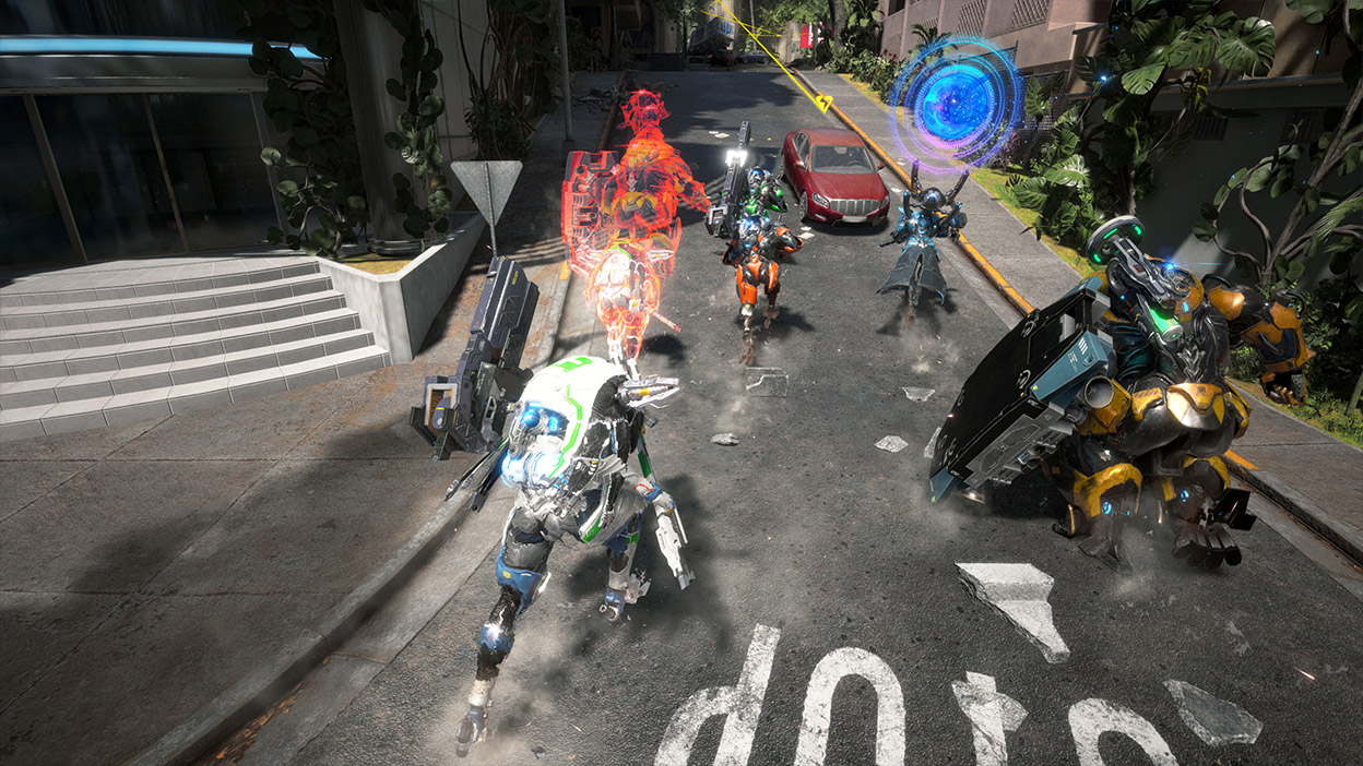 Five exosuits run up a city street.