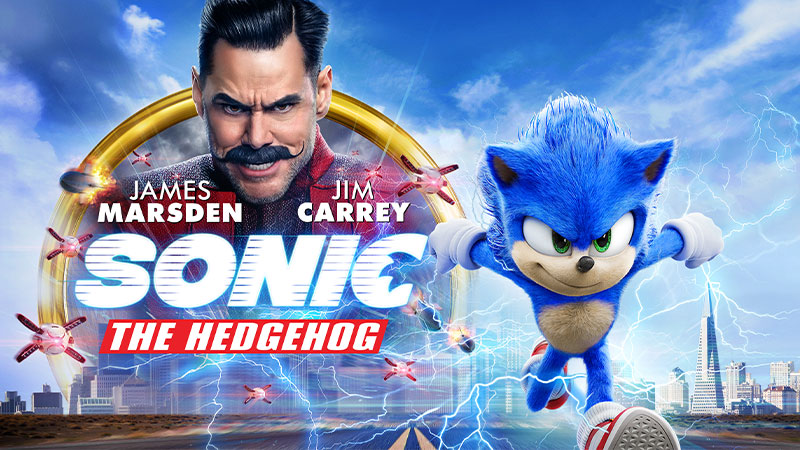 Sonic the Hedgehog starring James Marsden and Jim Carrey. Sonic runs away from rockets in front of a cityscape.