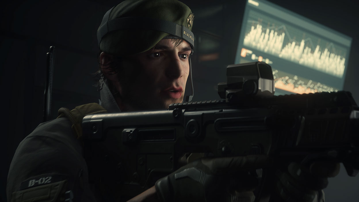 A mercenary in a green beret readies his gun in a dark room illuminated only by a tv screen.
