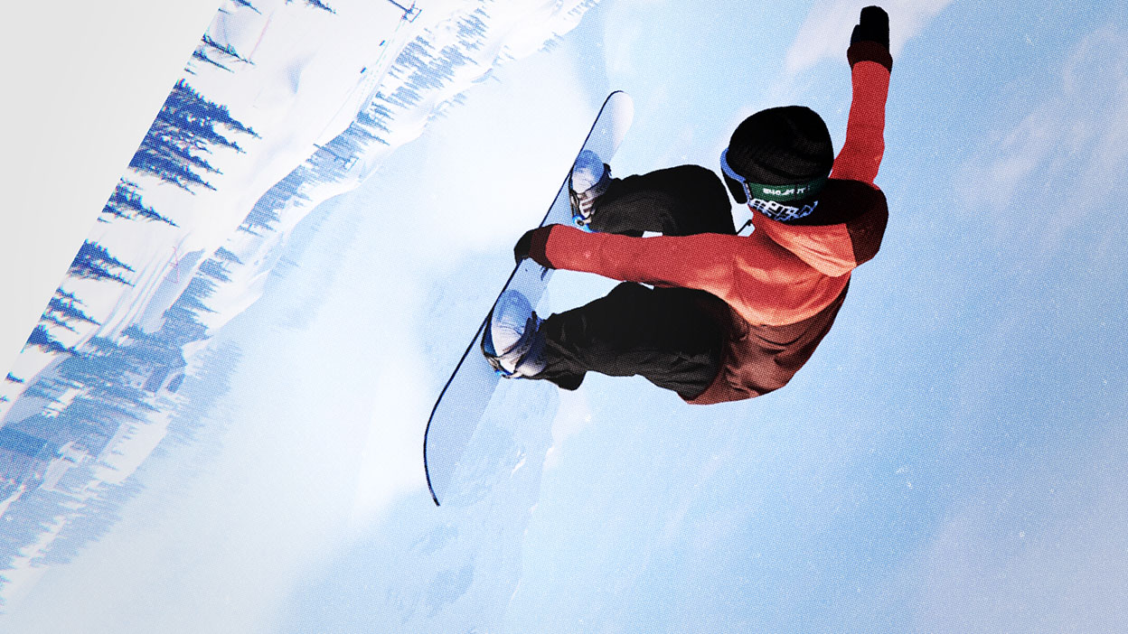 Un snowboardeur vole latéralement dans les airs en tenant sa planche d’une main.